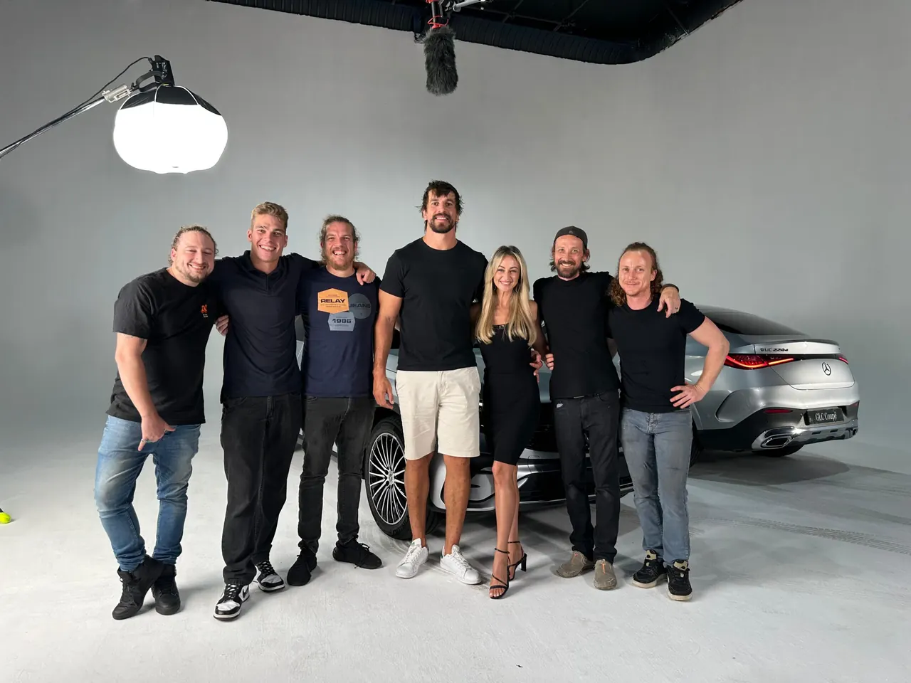 Production team on a studio cove with a silver car