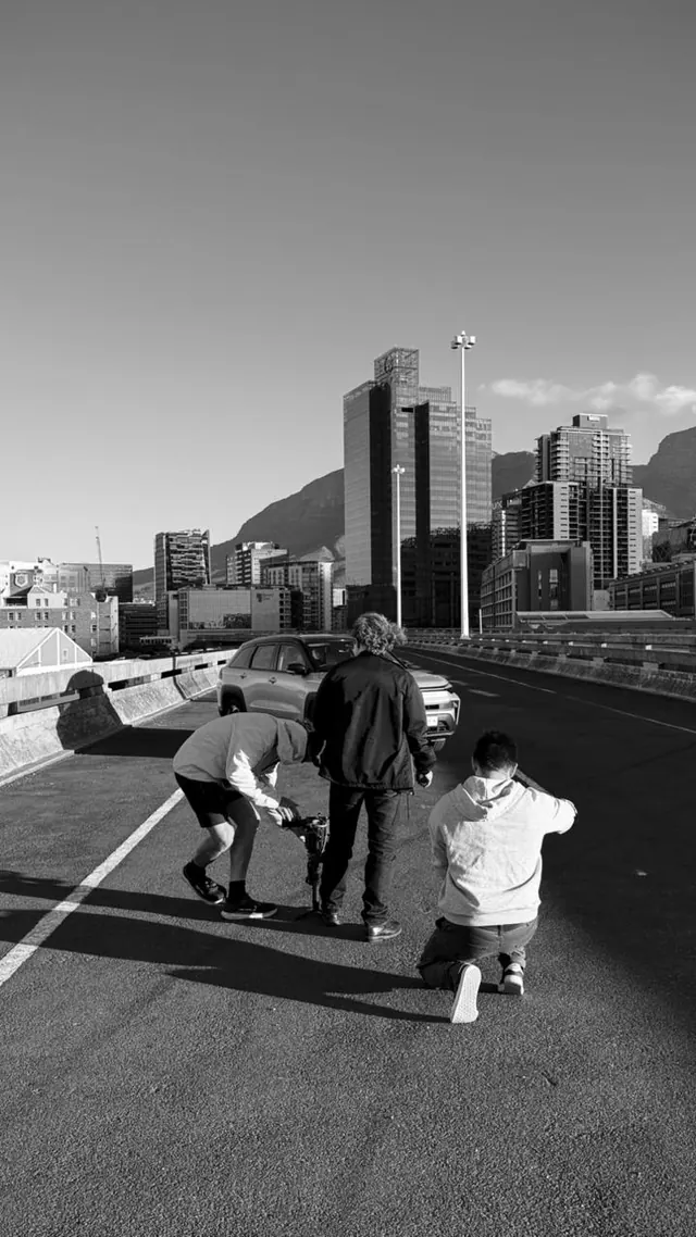Crew shooting on a city street, black and white