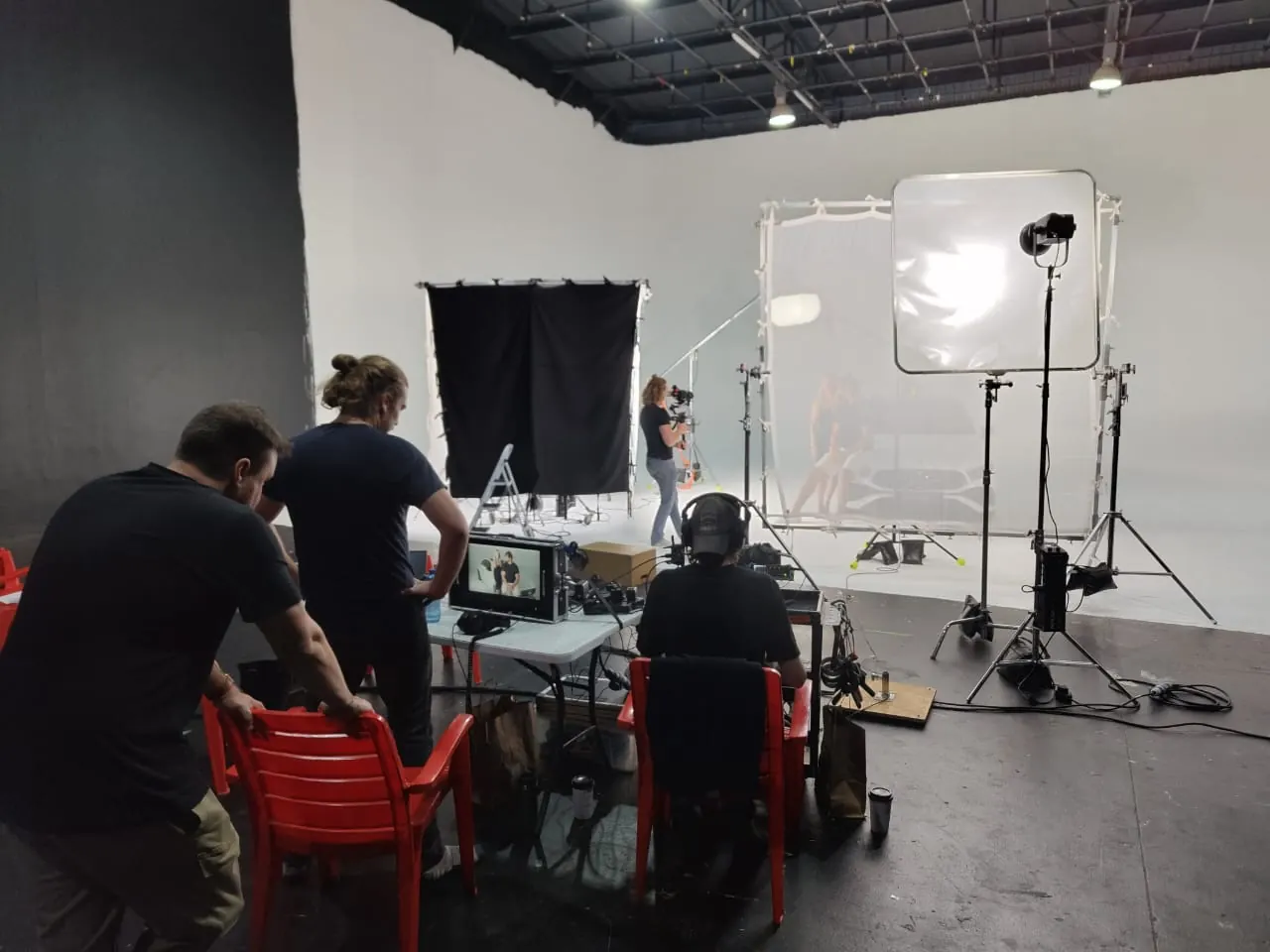 Video village with monitors and crew in studio